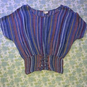 Multi-colored shirt with flowy and cinched halves.